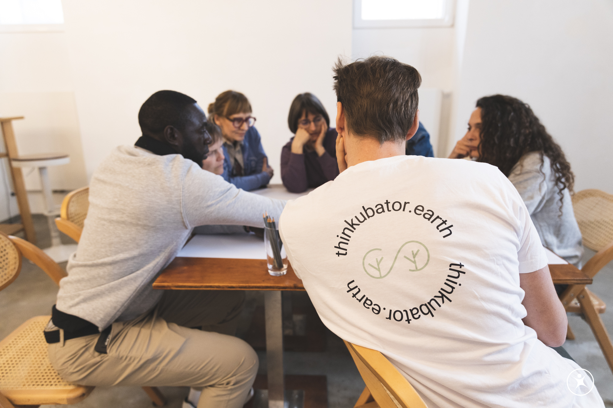 Gruppe im Gespräch an einem Tisch bei einem Thinkubator-Workshop