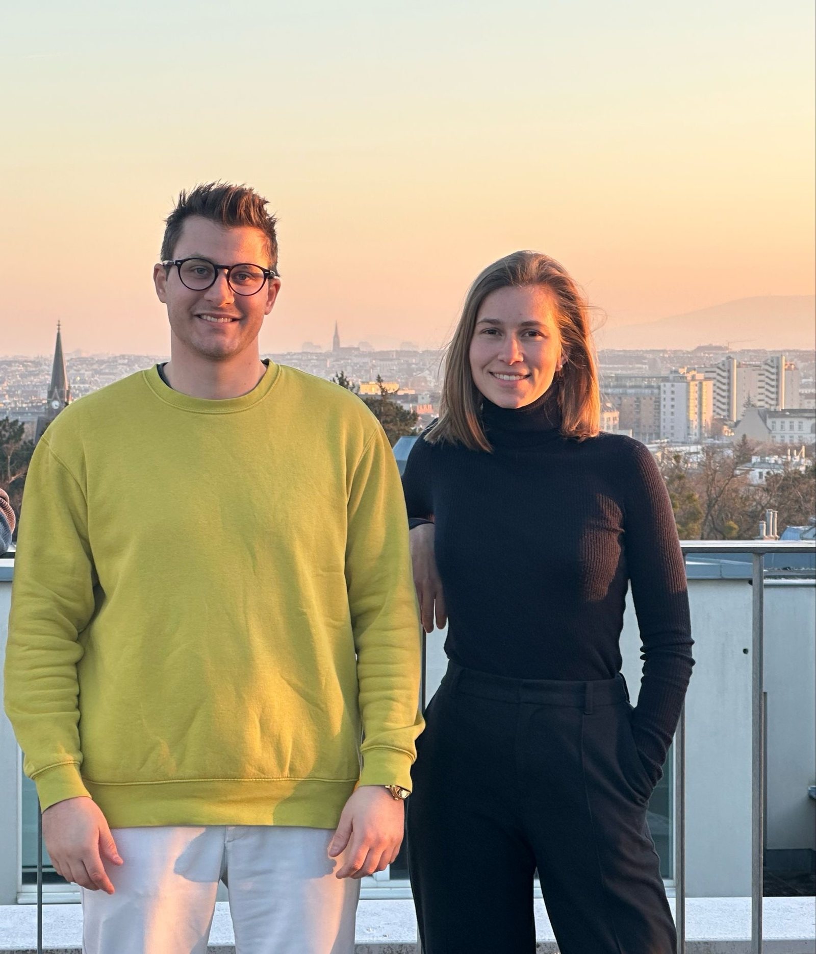 AeroVia’s two founders standing on a rooftop with a view over Vienna.
